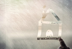 Condensation on a window in the shape of a house